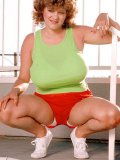 Big Breasted Curly Fattie Darlene Lupone Poses In Red Shorts And Green Top